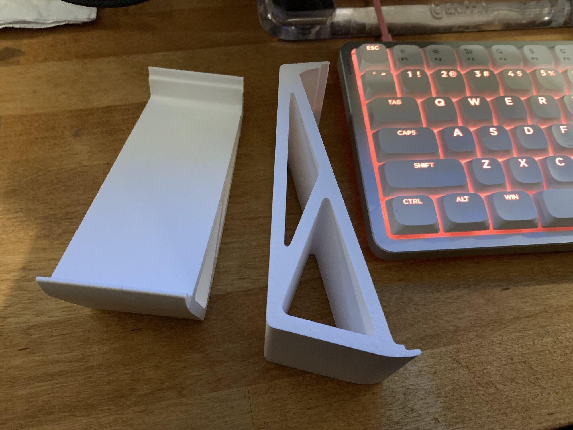 The finished pair of white 3D-printed keyboard lifters